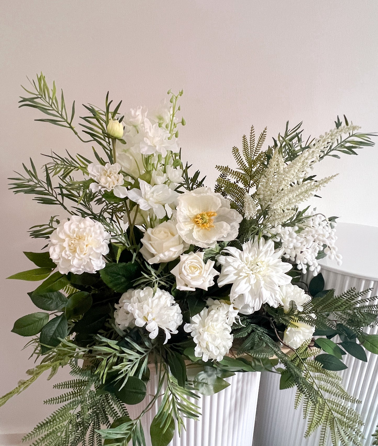 Closeup view of small faux arrangements with poppy, dahlia, poppies and wattle