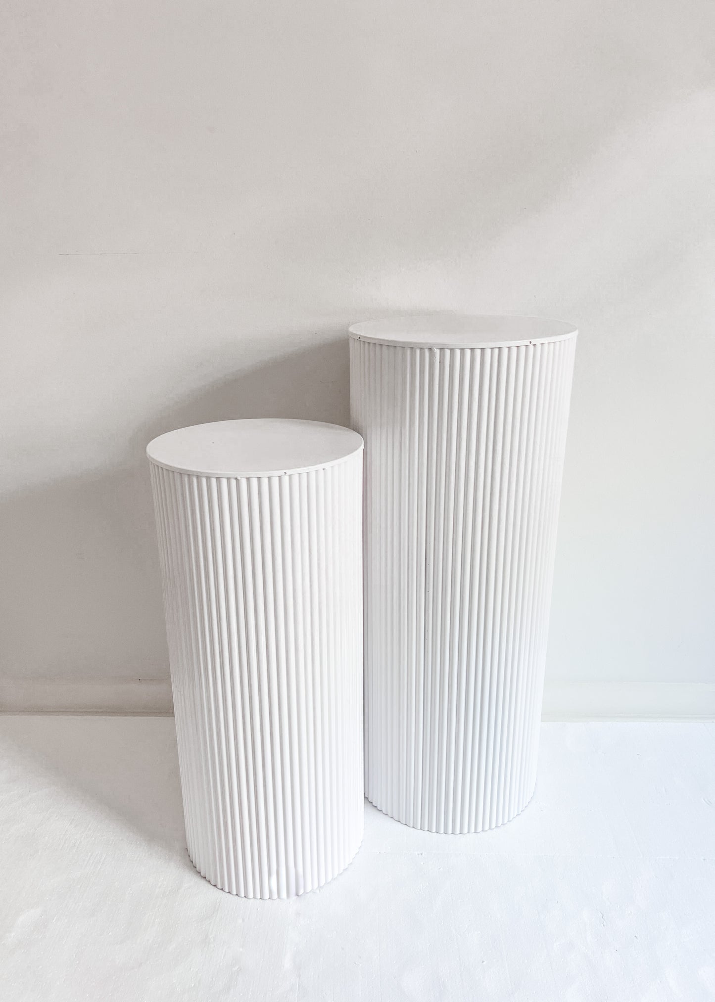 Shiny white metal plinths for hire